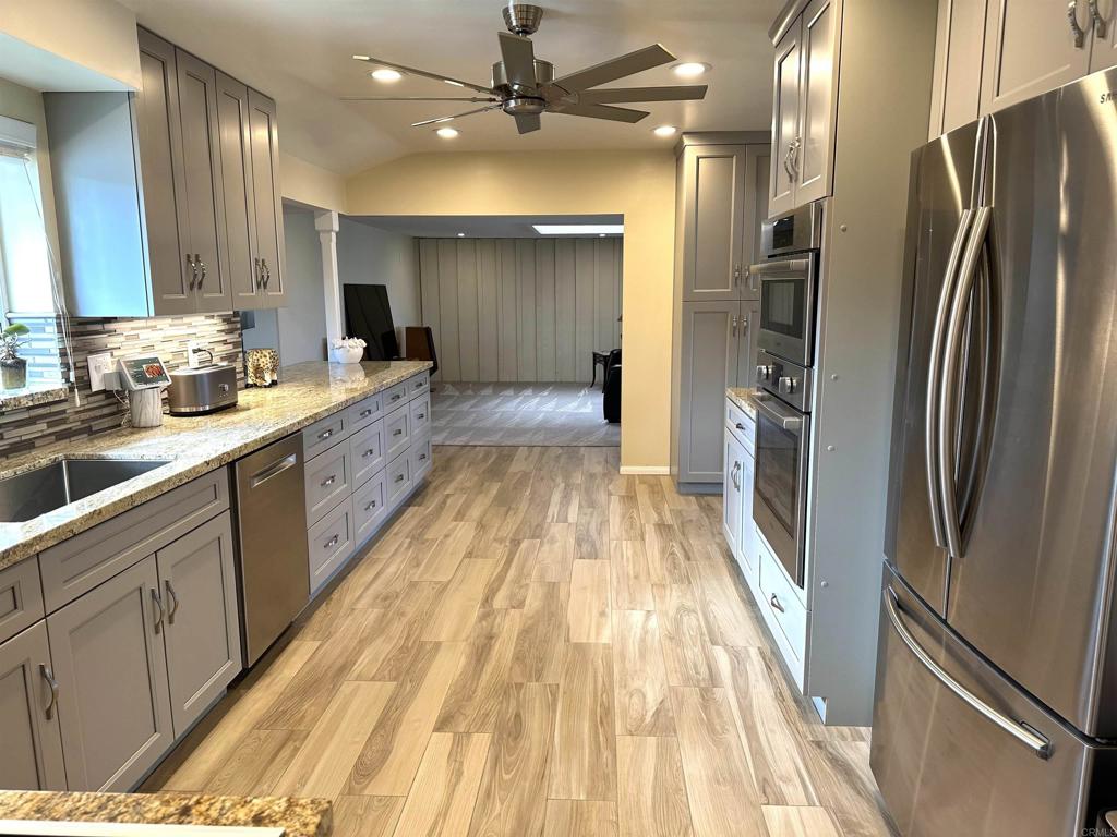 1001 Riverview Drive Fallbrook, CA 92028 - Photo 6 of 36 a large kitchen with a large counter top a sink stainless steel appliances and cabinets