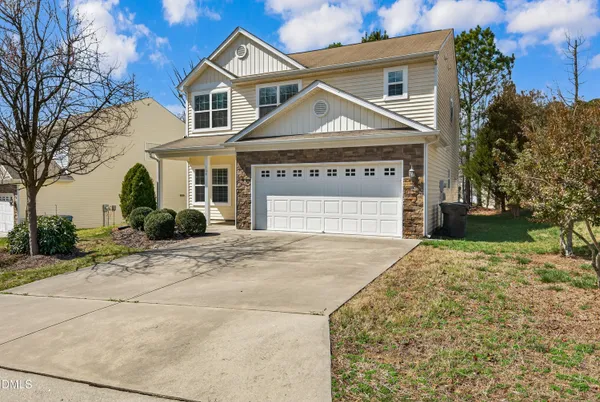 a front view of a house with a yard and garage