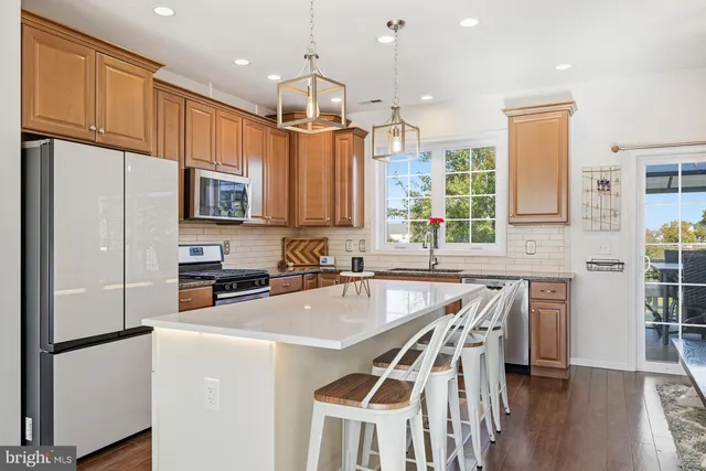 a kitchen with granite countertop a sink stainless steel appliances and counter space