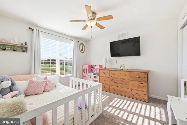 a bedroom with a bed and flat screen tv