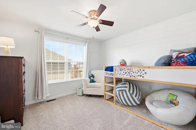 a bedroom with furniture and a window