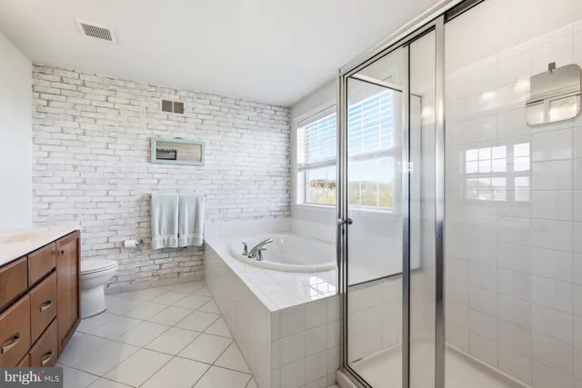a bathroom with a tub a sink and a shower