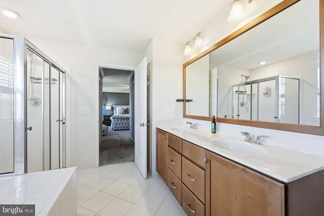 a spacious bathroom with a double vanity sink mirror and