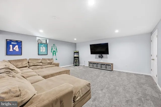 a living room with a flat screen tv and a couch