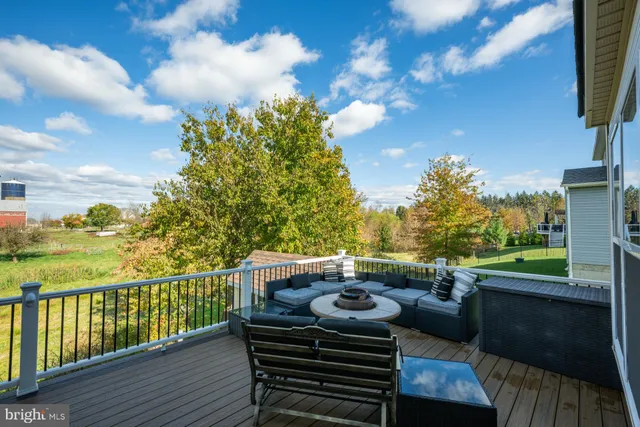 a view of a balcony with two chairs and a swing