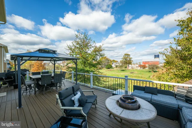 a view of a balcony with chairs and wooden floor