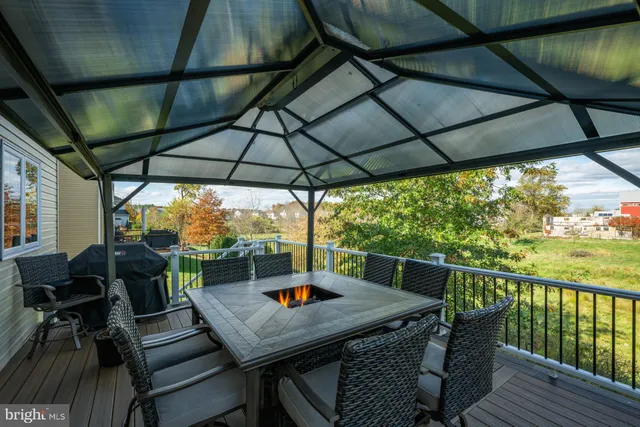 a view of porch with furniture and umbrella