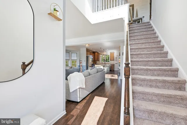 a living room with furniture and a stair
