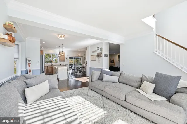 a living room with furniture and view of kitchen