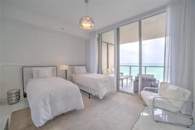 a spacious bedroom with two beds and large windows