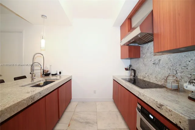 a kitchen with granite countertop a sink and a stove