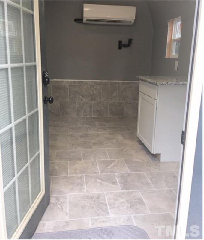100 Sturbridge Road Raleigh, NC 27615 - Photo 15 of 17 Yep. That is a split system A/C unit, tile floors and countertop.