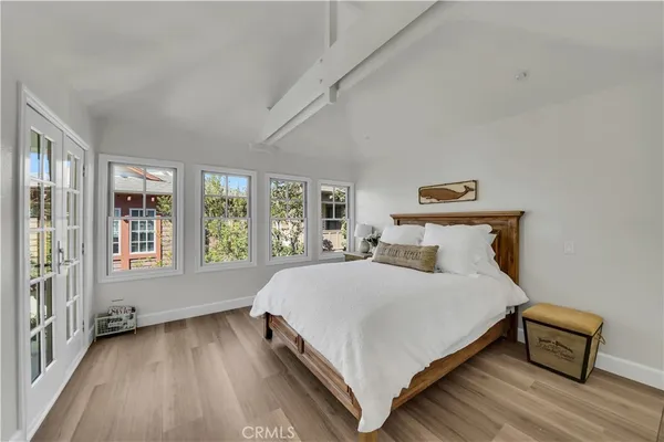 a bedroom with a bed and a large window