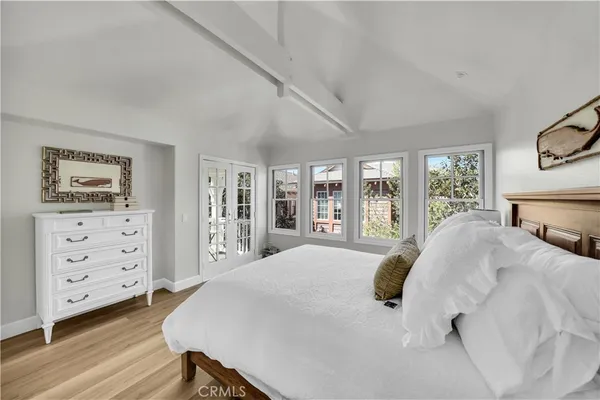 a bedroom with a large bed and a window