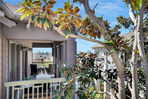 a front view of a house with a tree