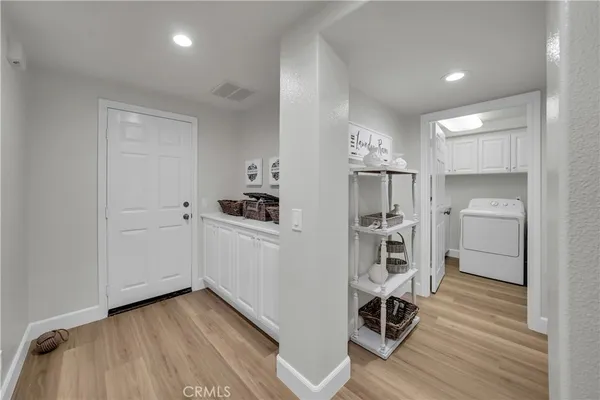 a view of a kitchen with wooden floor and a sink