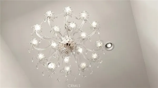 a view of a chandelier fan and window