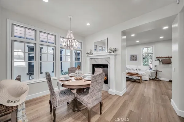 a living room with furniture a fireplace and a chandelier