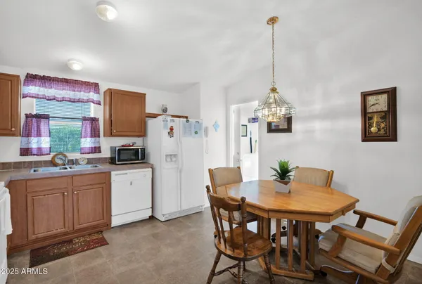 a view of a dining room with furniture and a chandelier