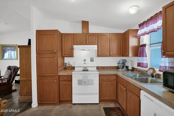 a kitchen with a sink stove and refrigerator