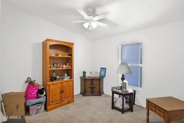 a workspace with furniture and a ceiling fan