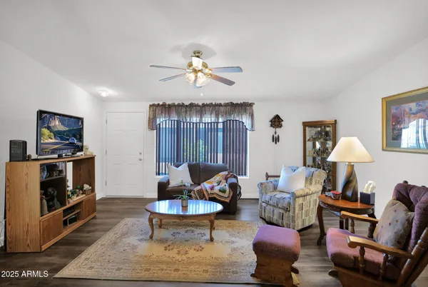 a living room with furniture a rug and a chandelier