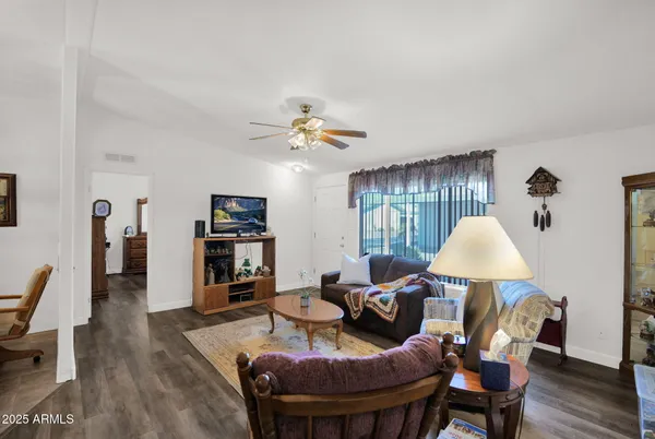 a living room with furniture and a wooden floor