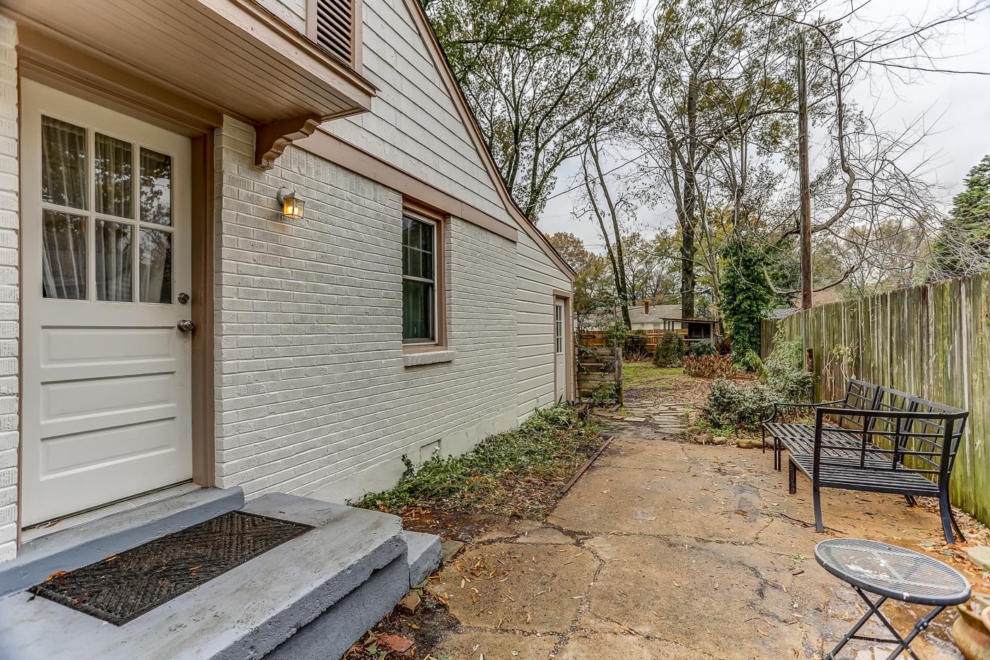 767 Berry Road Memphis, TN 38117 - Photo 14 of 16 a view of a backyard with a large tree