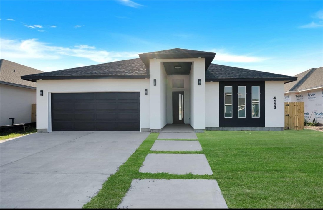 4113 Midlands Street Corpus Christi, TX 78414 - Photo 1 of 35 a front view of a house with a yard and garage