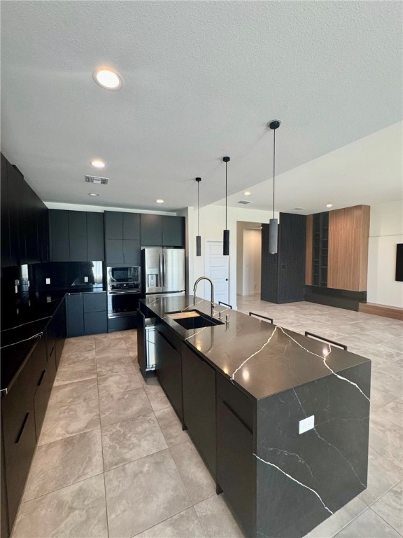 4113 Midlands Street Corpus Christi, TX 78414 - Photo 10 of 35 a large kitchen with stainless steel appliances kitchen island granite countertop a sink and white cabinets