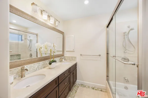 a bathroom with a double vanity sink mirror and double