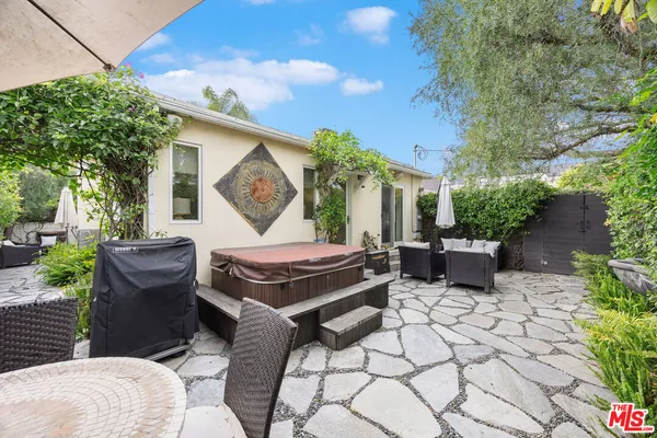 a view of a backyard with sitting area