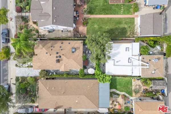 an aerial view of a house with a garden and trees