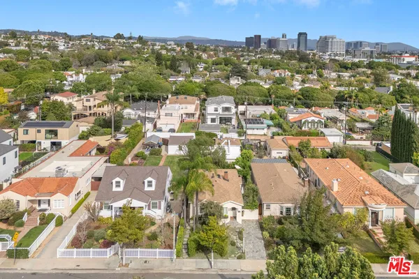 an aerial view of residential houses with city view