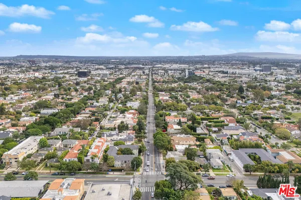 an aerial view of residential building with green space