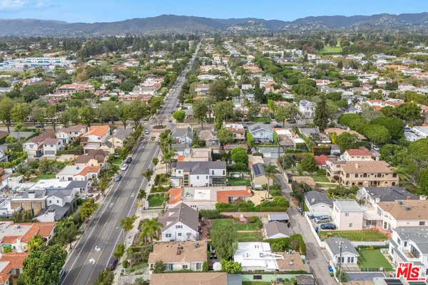 an aerial view of residential houses with city view