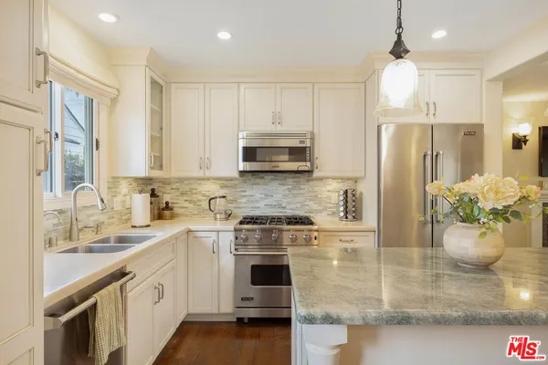 a kitchen with a stove microwave and refrigerator