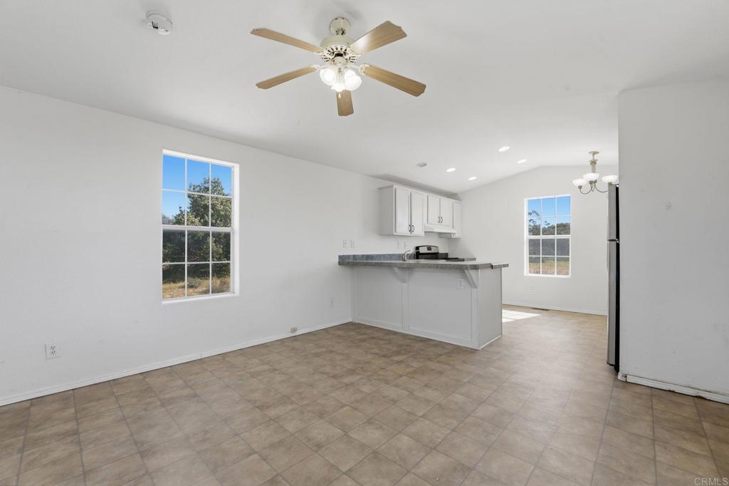 909 Tierra De Luna Road Boulevard, CA 91905 - Photo 13 of 74 a view of kitchen with kitchen island white cabinets and refrigerator