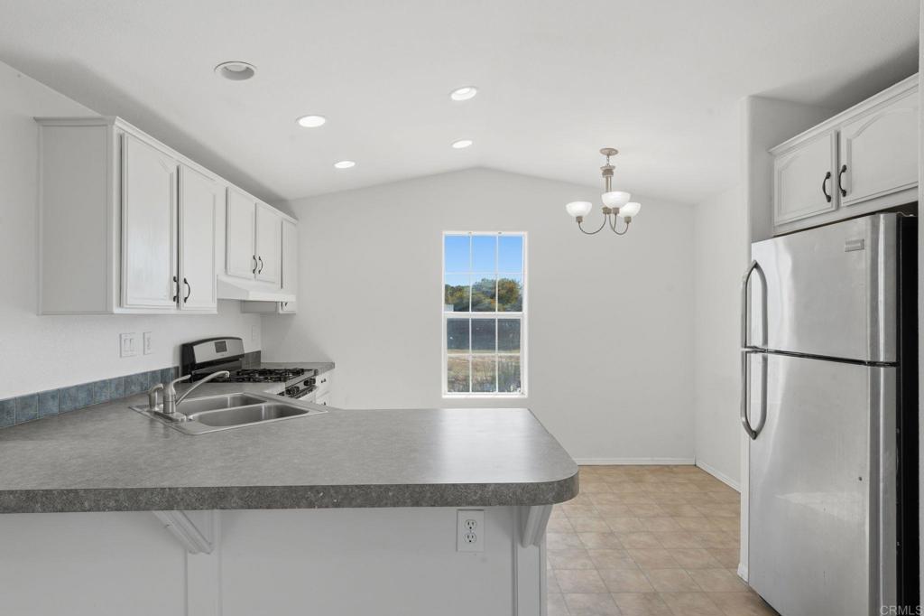 909 Tierra De Luna Road Boulevard, CA 91905 - Photo 15 of 74 a kitchen with stainless steel appliances granite countertop a refrigerator sink and cabinets