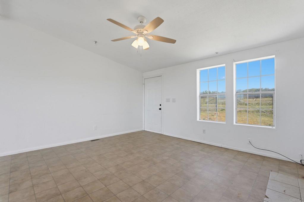 909 Tierra De Luna Road Boulevard, CA 91905 - Photo 28 of 74 an empty room with windows and fan