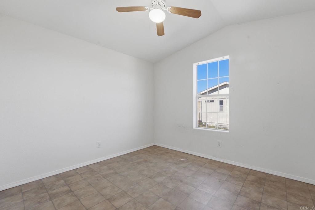 909 Tierra De Luna Road Boulevard, CA 91905 - Photo 38 of 74 an empty room with a chandelier fan