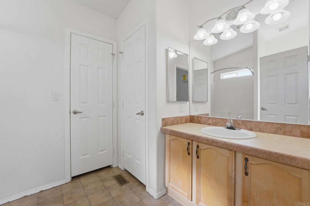 909 Tierra De Luna Road Boulevard, CA 91905 - Photo 41 of 74 a bathroom with a sink vanity and a mirror
