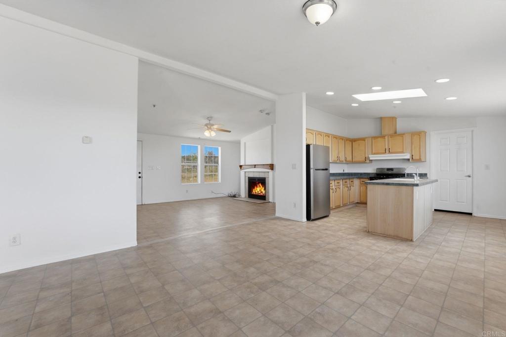 909 Tierra De Luna Road Boulevard, CA 91905 - Photo 5 of 74 a view of a kitchen with refrigerator and white cabinets