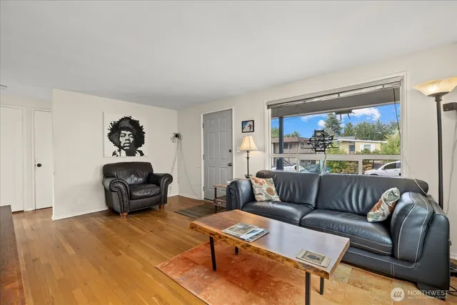 a living room with furniture rug and a large window