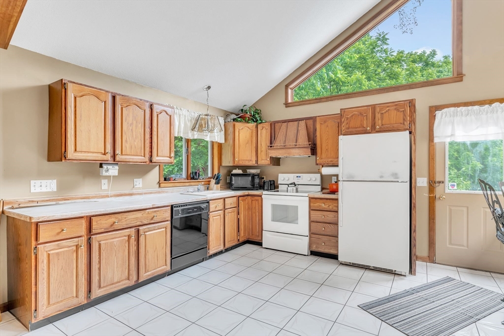 81 Munn Road Monson, MA 01057 - Photo 15 of 42 a kitchen with white cabinets and white appliances
