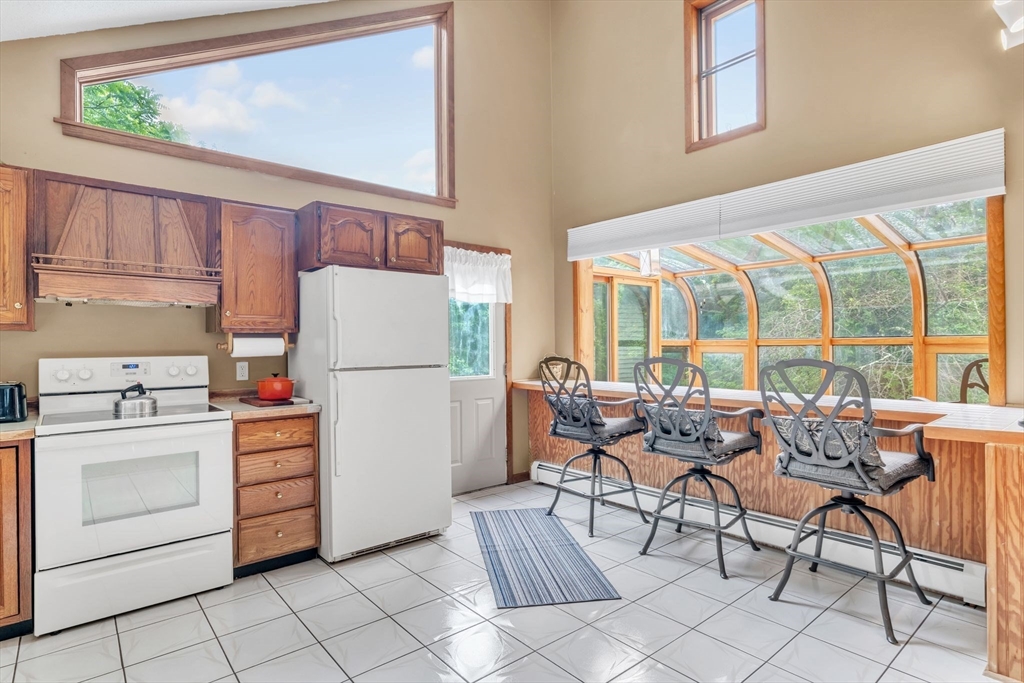 81 Munn Road Monson, MA 01057 - Photo 17 of 42 a kitchen with a stove a refrigerator and a dining table