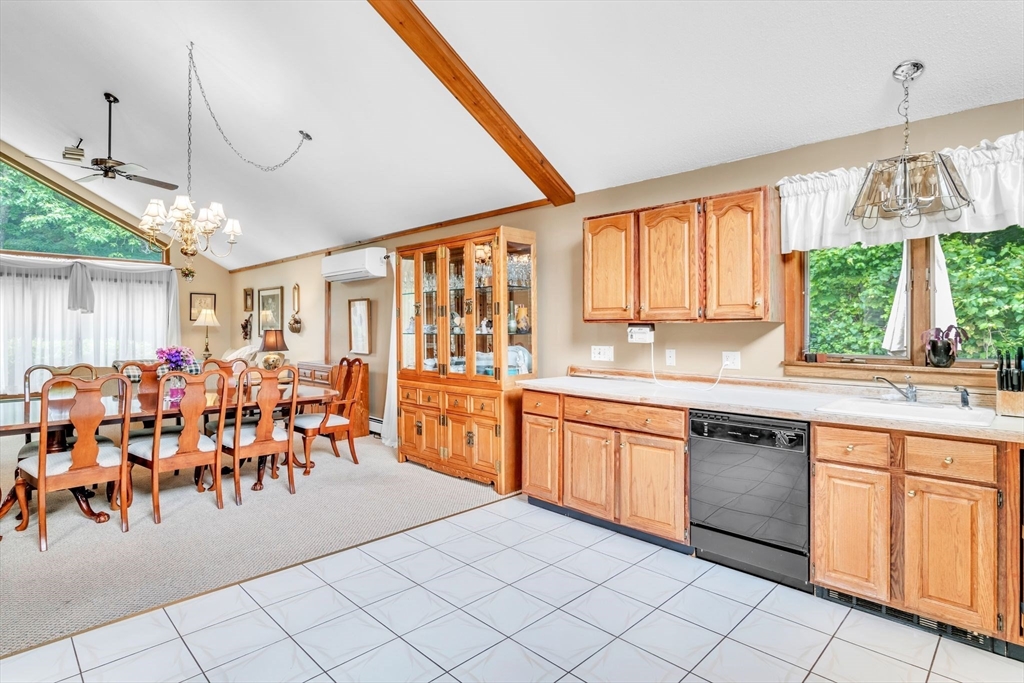 81 Munn Road Monson, MA 01057 - Photo 19 of 42 a large kitchen with white cabinets and wooden floors