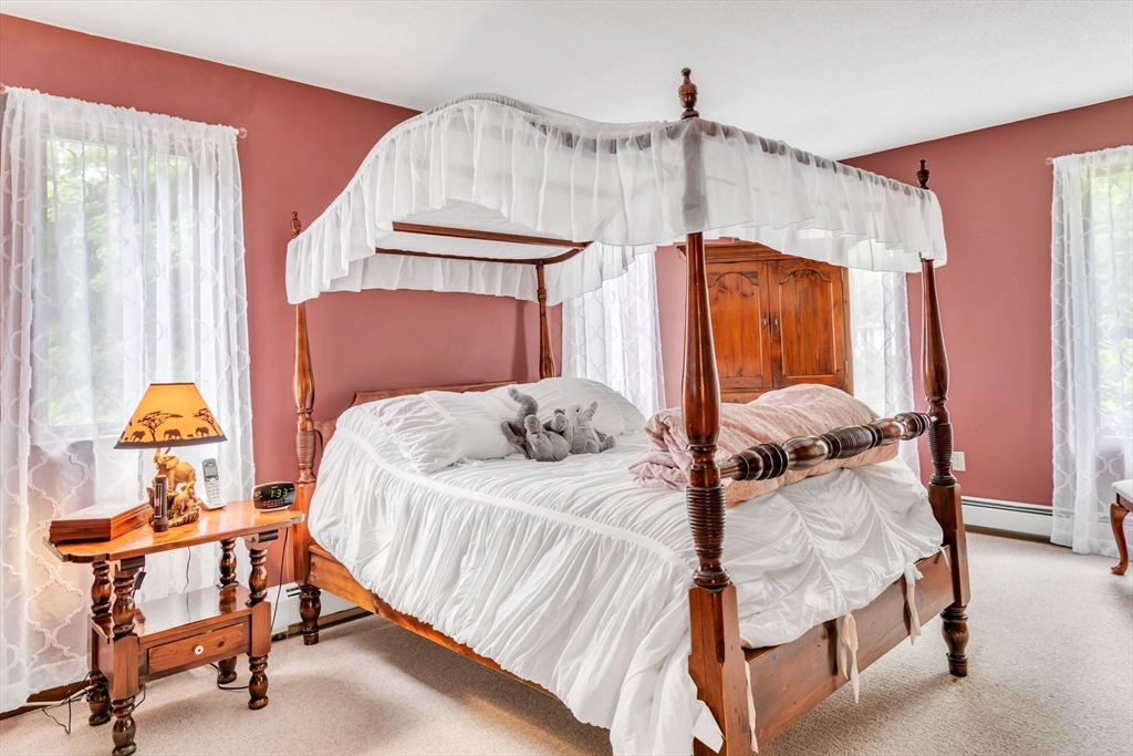 81 Munn Road Monson, MA 01057 - Photo 24 of 42 a bedroom with a bed and a chandelier