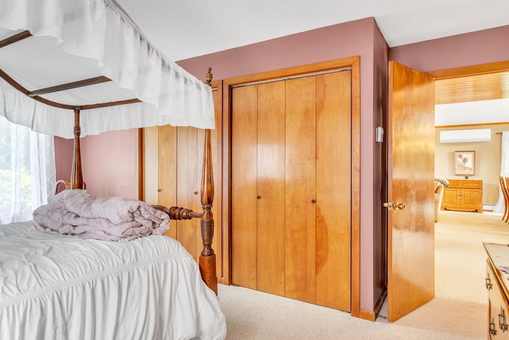 81 Munn Road Monson, MA 01057 - Photo 25 of 42 a bedroom with a bed and a chandelier