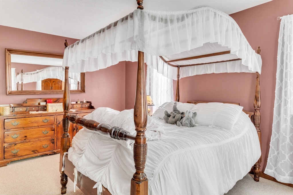 81 Munn Road Monson, MA 01057 - Photo 26 of 42 a bedroom with a bed and dresser with the large mirror